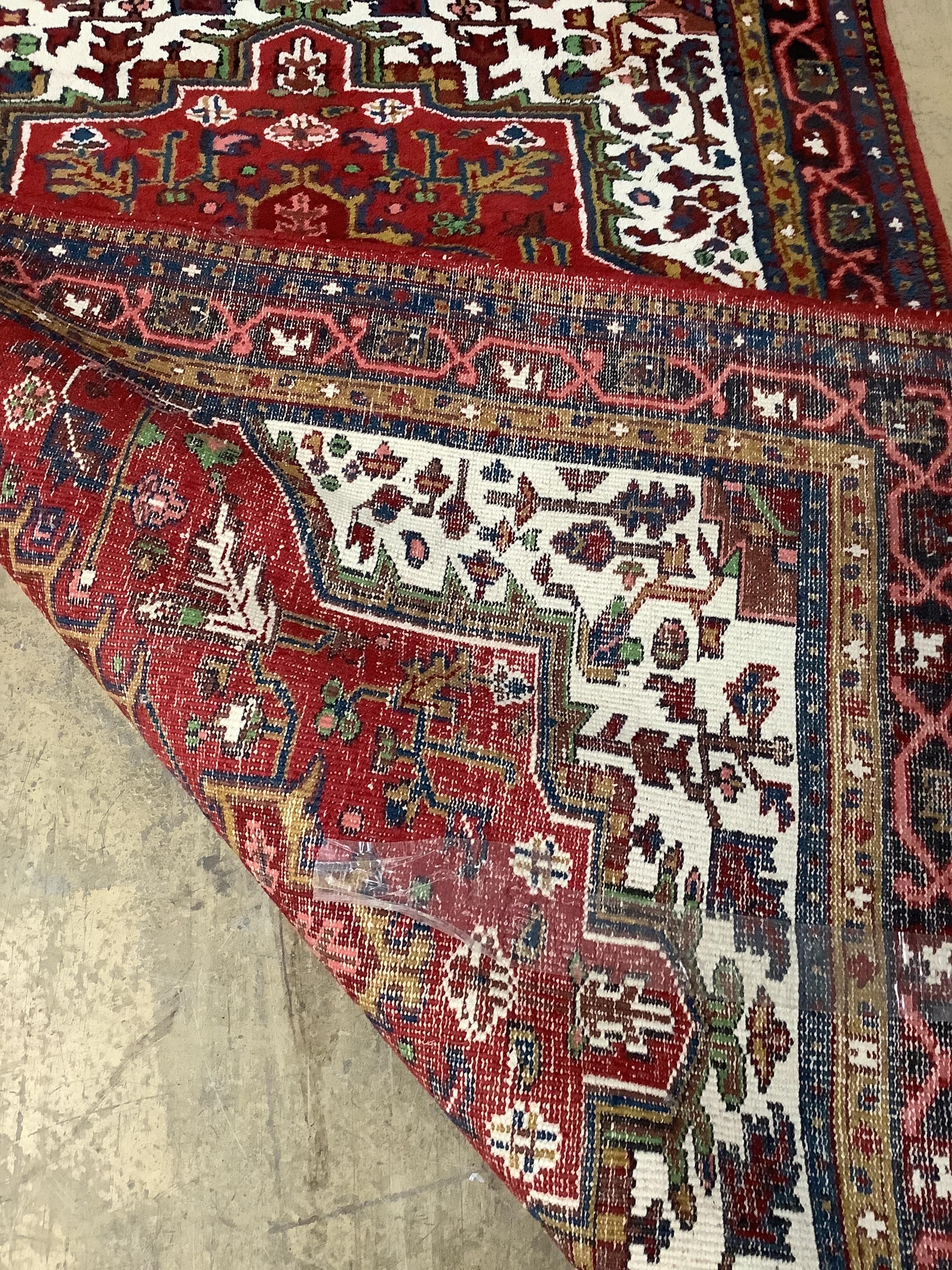 A Caucasian style red ground rug, 200 x 142cm